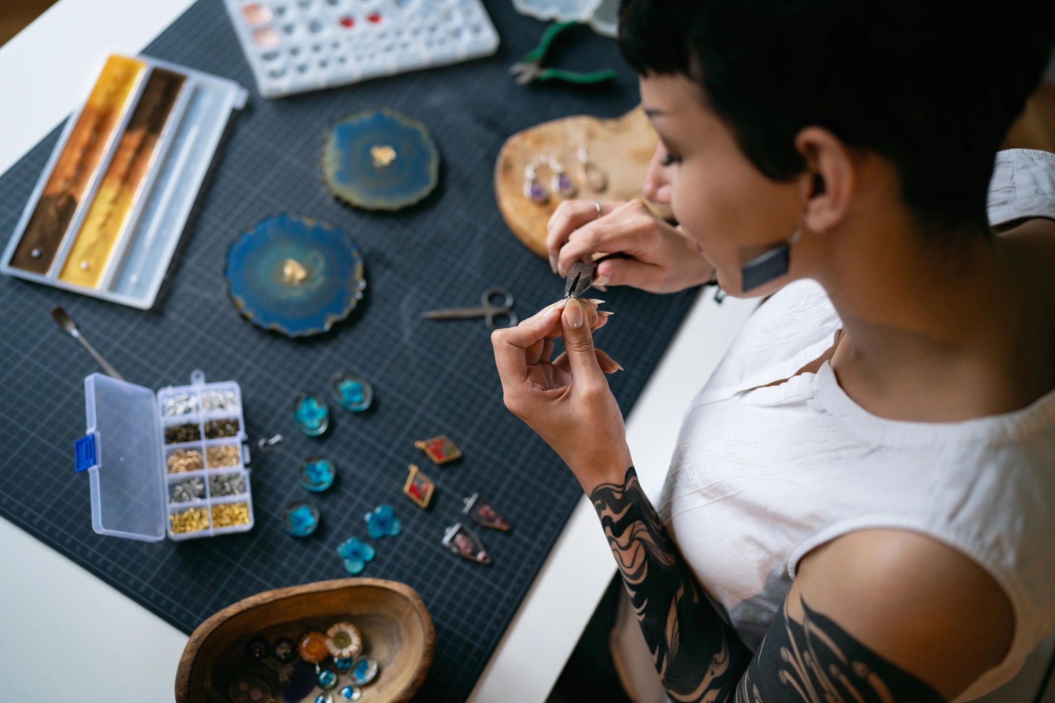 Jewelry maker working carefully with tools at a workshop